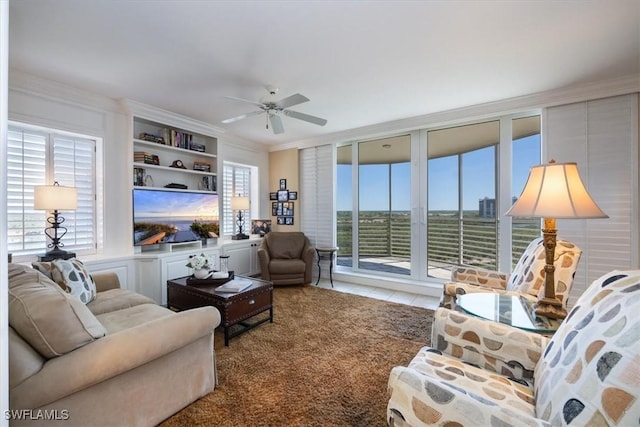 living room featuring a ceiling fan and ornamental molding