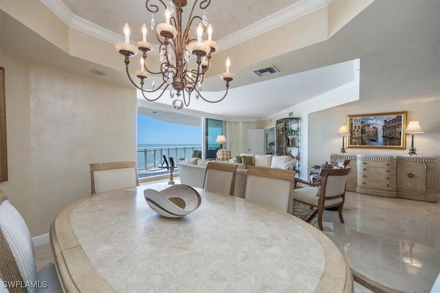 dining room featuring a tray ceiling, visible vents, a chandelier, and crown molding