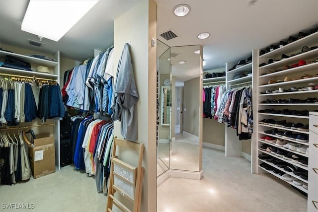 walk in closet featuring visible vents and carpet