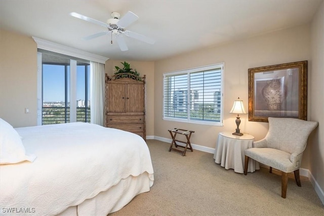 bedroom with access to exterior, ceiling fan, light carpet, and baseboards