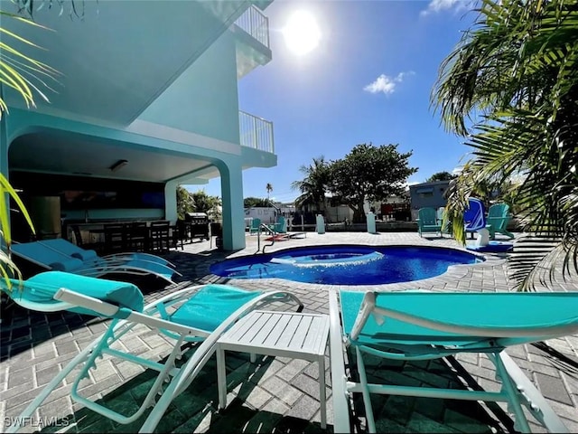 view of swimming pool featuring an in ground hot tub, a patio area, and a fenced in pool