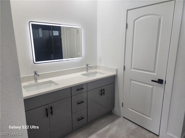 651 Knapp St, Lehigh Acres, FL 33974 - full bathroom with double vanity, marble finish floor, and a sink