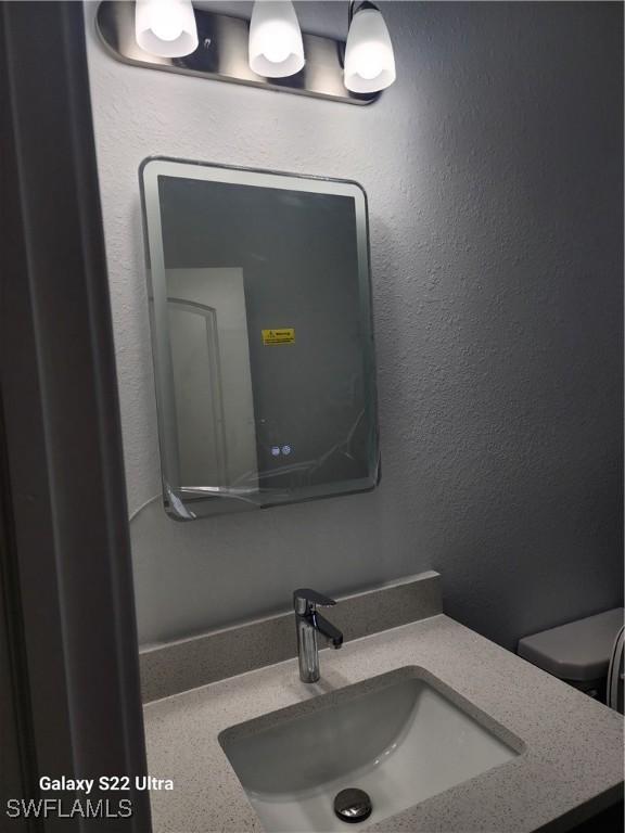 651 Knapp St, Lehigh Acres, FL 33974 - bathroom featuring toilet and vanity