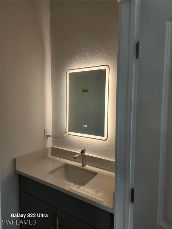 651 Knapp St, Lehigh Acres, FL 33974 - bathroom featuring a textured wall and vanity