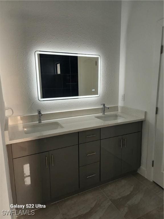 651 Knapp St, Lehigh Acres, FL 33974 - bathroom featuring double vanity, a sink, and a textured wall