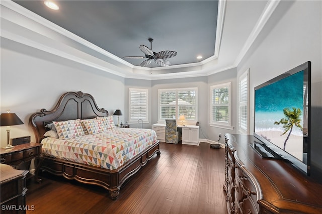 bedroom featuring baseboards, a tray ceiling, recessed lighting, hardwood / wood-style flooring, and crown molding