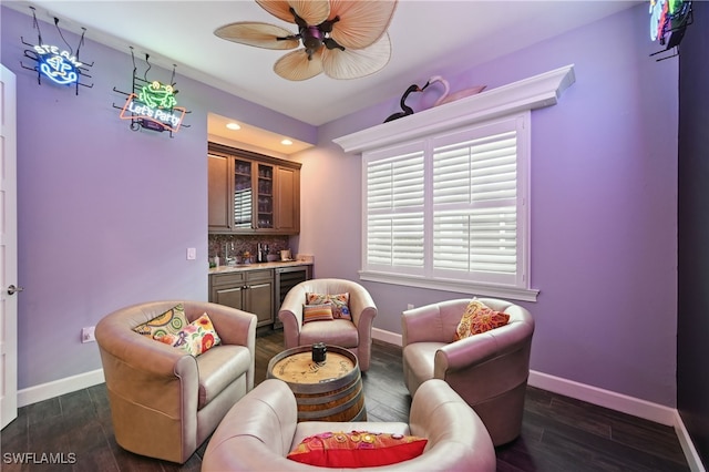 living area with dark wood-style floors, baseboards, a ceiling fan, wet bar, and wine cooler