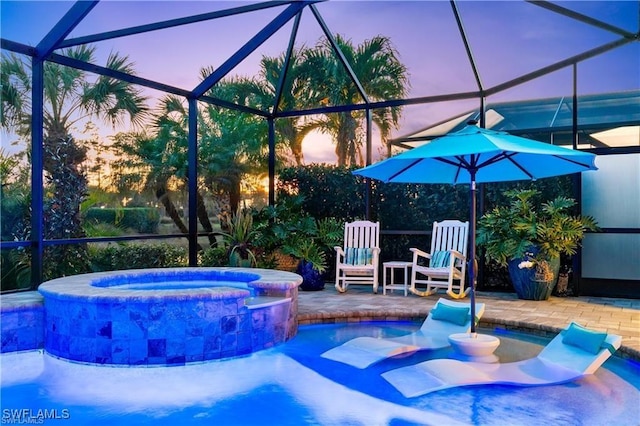 view of pool featuring a patio area, a pool with connected hot tub, and a lanai