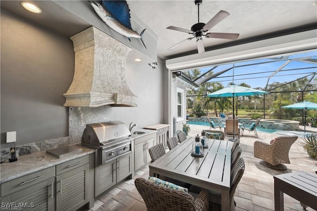 view of patio / terrace with ceiling fan, a lanai, grilling area, and an outdoor kitchen