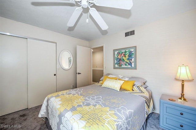 bedroom featuring a closet, visible vents, ceiling fan, and carpet flooring