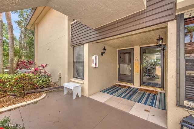 entrance to property with stucco siding