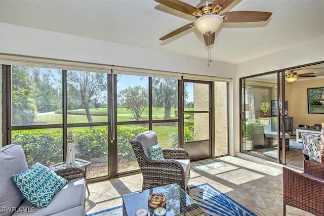 sunroom featuring a ceiling fan