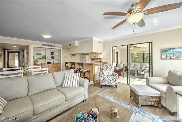 living room featuring wood finished floors and crown molding