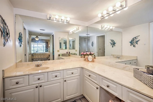 ensuite bathroom with ceiling fan, connected bathroom, and vanity