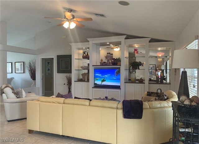 living room with ceiling fan, visible vents, vaulted ceiling, and light tile patterned flooring