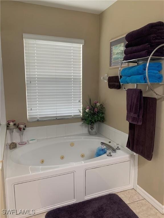 full bathroom with a jetted tub and tile patterned floors