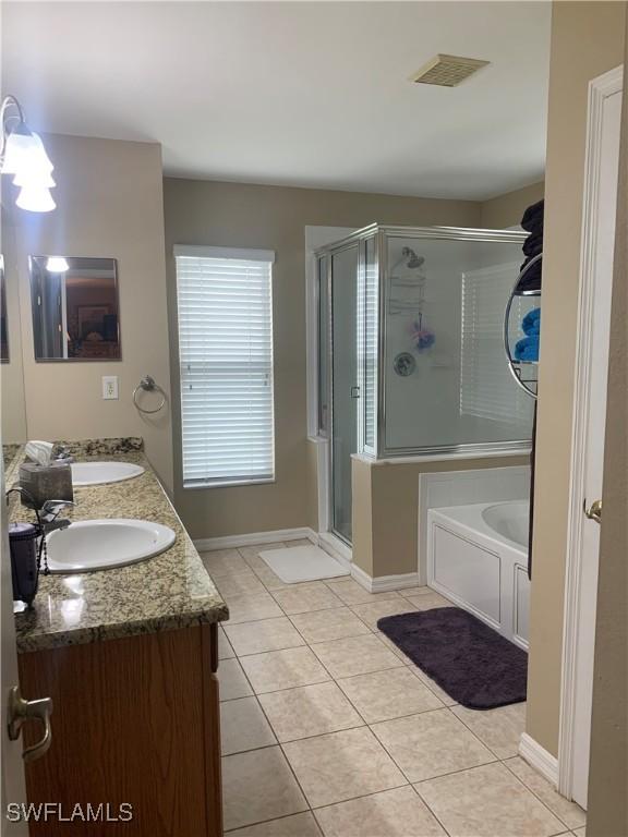 full bathroom with a stall shower, visible vents, a sink, and tile patterned floors