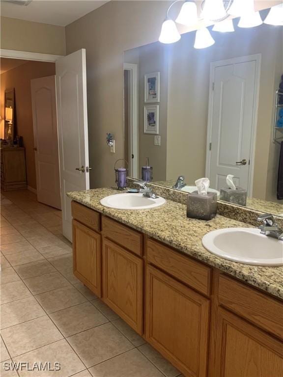 bathroom featuring double vanity, tile patterned flooring, and a sink