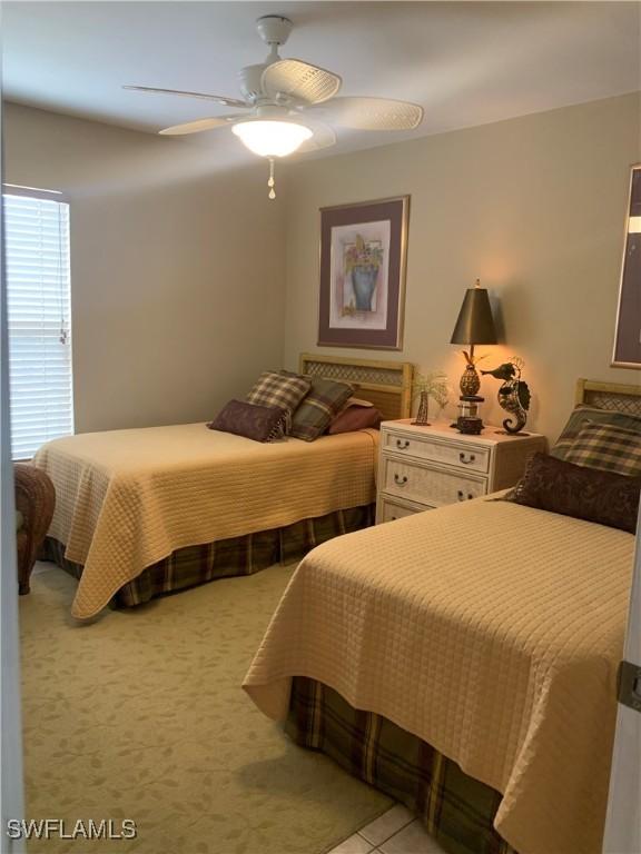 bedroom with light tile patterned floors and ceiling fan