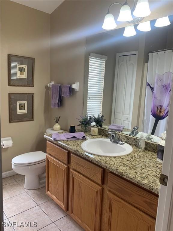 full bath featuring vanity, toilet, and tile patterned floors