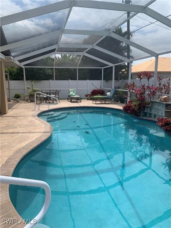 view of pool featuring fence, a fenced in pool, and a patio