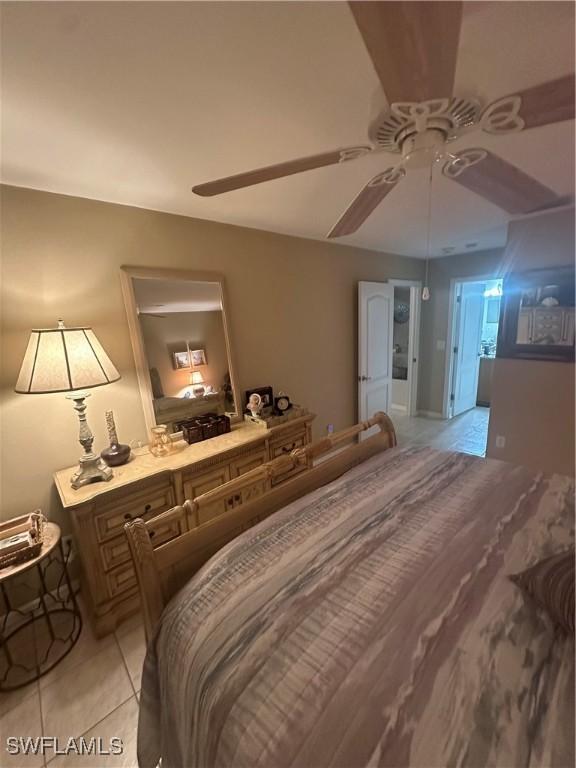 bedroom with a ceiling fan and light tile patterned floors