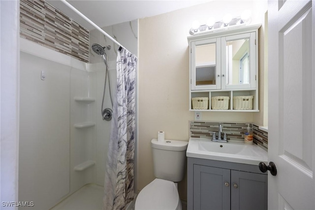 bathroom with vanity, toilet, tasteful backsplash, and a stall shower