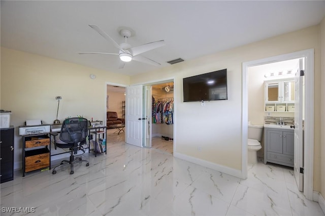 office area featuring baseboards, visible vents, ceiling fan, a sink, and marble finish floor