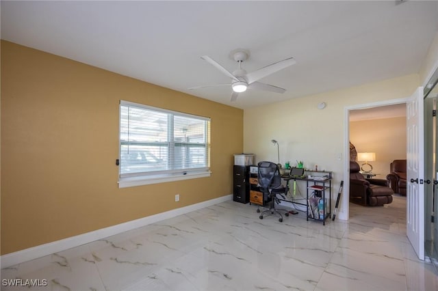 home office with a ceiling fan, baseboards, and marble finish floor