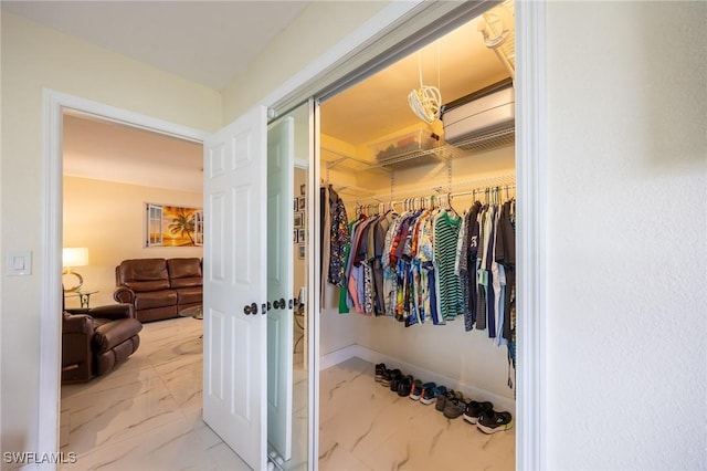 spacious closet featuring marble finish floor