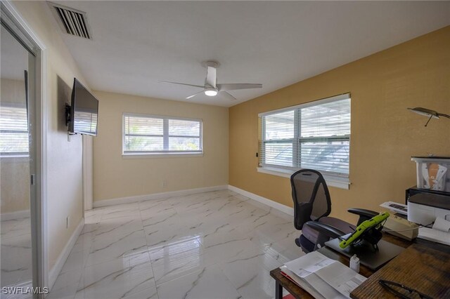 unfurnished office with a wealth of natural light, visible vents, baseboards, and marble finish floor