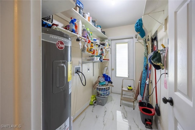 clothes washing area with laundry area, marble finish floor, electric water heater, and washer hookup