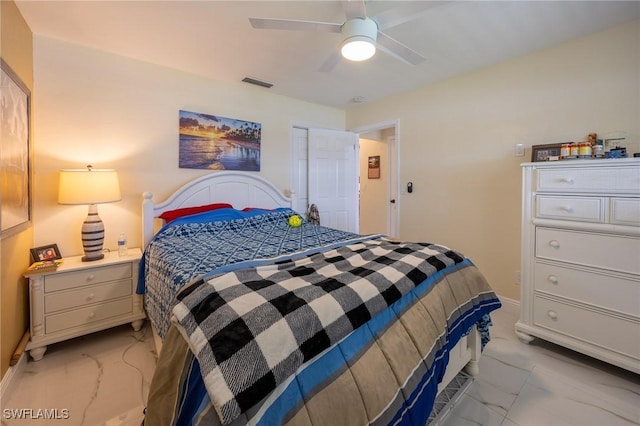 bedroom with visible vents, marble finish floor, and a ceiling fan