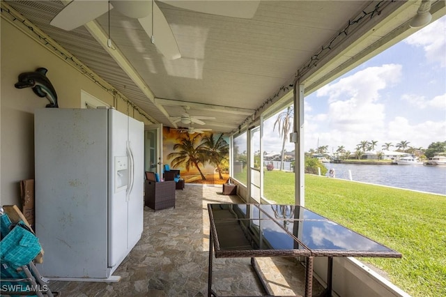 view of patio featuring a ceiling fan and a water view