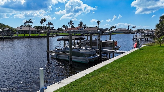 view of dock with boat lift, a residential view, a yard, and a water view