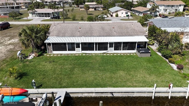 drone / aerial view featuring a residential view and a water view