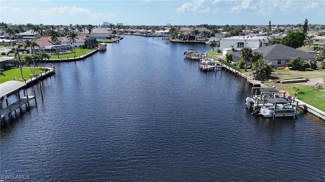 drone / aerial view featuring a residential view and a water view