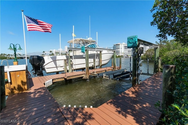 view of dock with boat lift and a water view