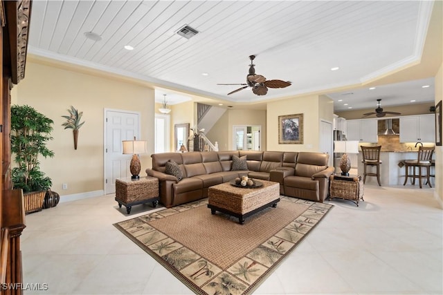 living room with visible vents, recessed lighting, crown molding, and baseboards