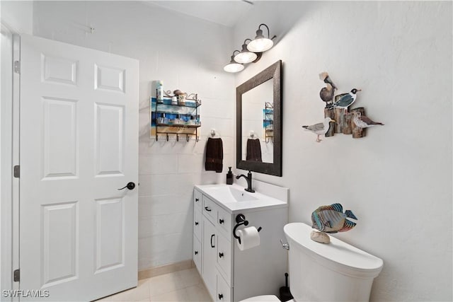 bathroom with vanity, tile patterned floors, and toilet