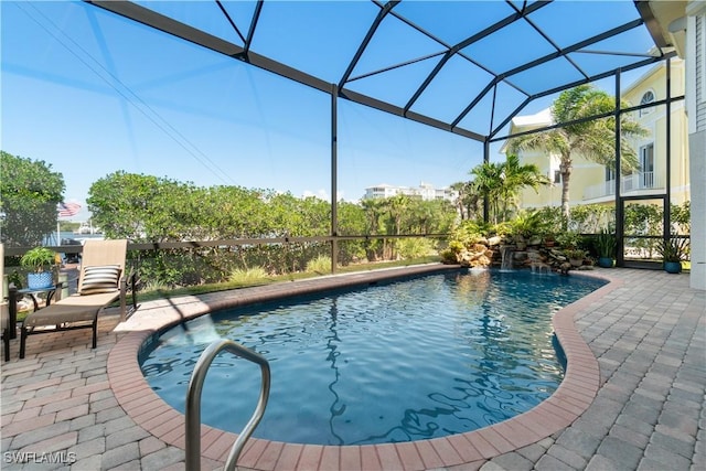 outdoor pool with a patio and a lanai