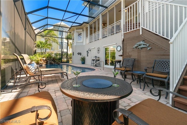 view of patio with glass enclosure, a jacuzzi, and an outdoor pool