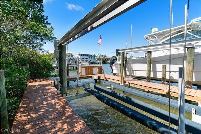 view of dock featuring a water view and boat lift