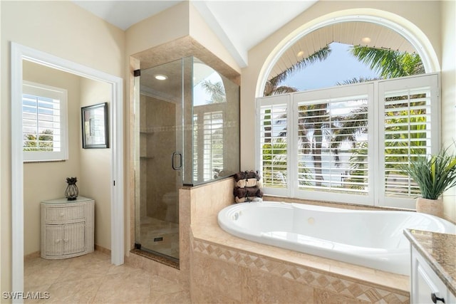 full bathroom featuring vanity, a garden tub, plenty of natural light, and a stall shower