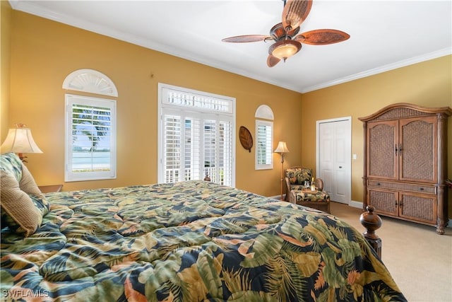 bedroom with baseboards, carpet floors, ornamental molding, and a ceiling fan