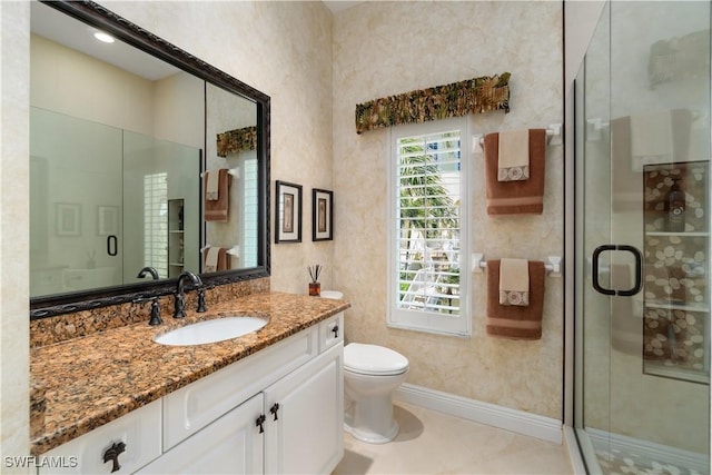 bathroom with a stall shower, toilet, and vanity