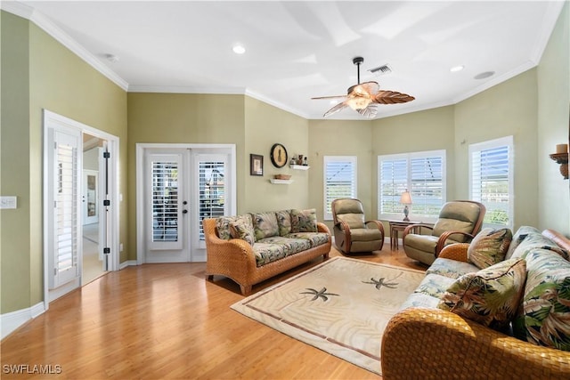 living area featuring wood finished floors, baseboards, french doors, and ornamental molding