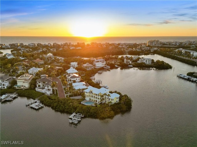 aerial view at dusk with a water view