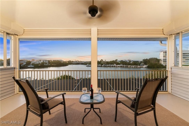 view of patio / terrace with a balcony and a water view