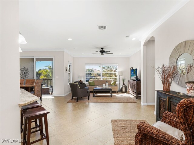 living area with light tile patterned floors, recessed lighting, baseboards, and ornamental molding